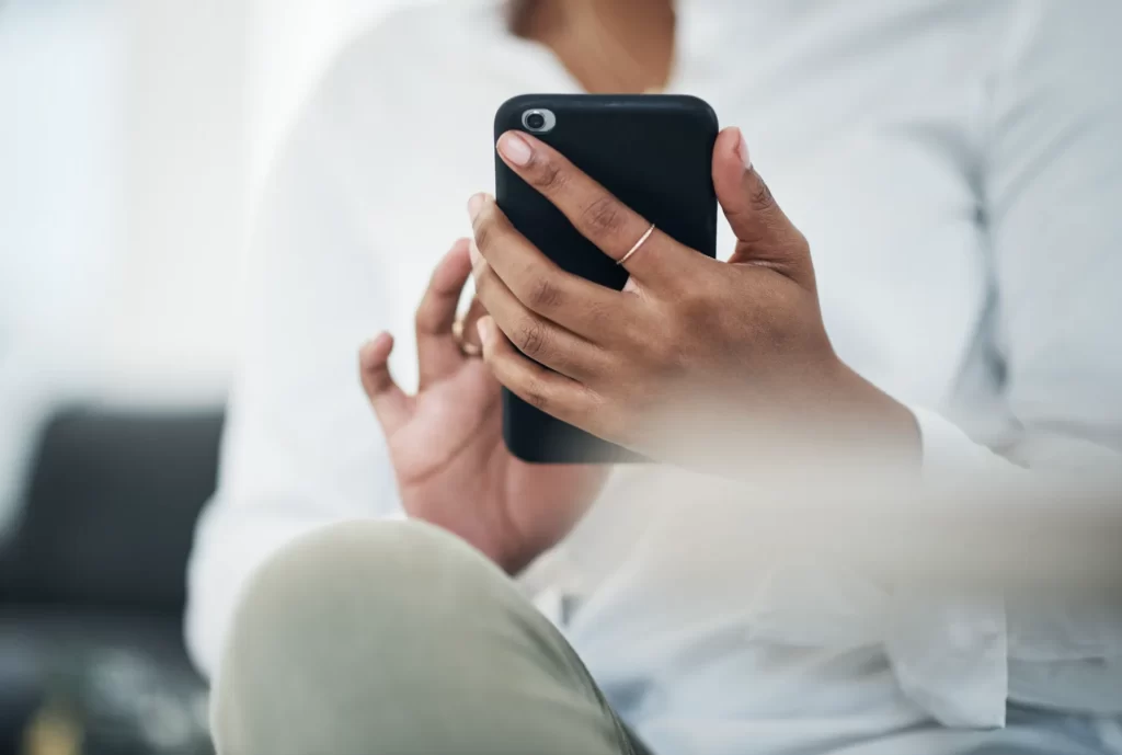 woman using smart phone in relaxed setting utc